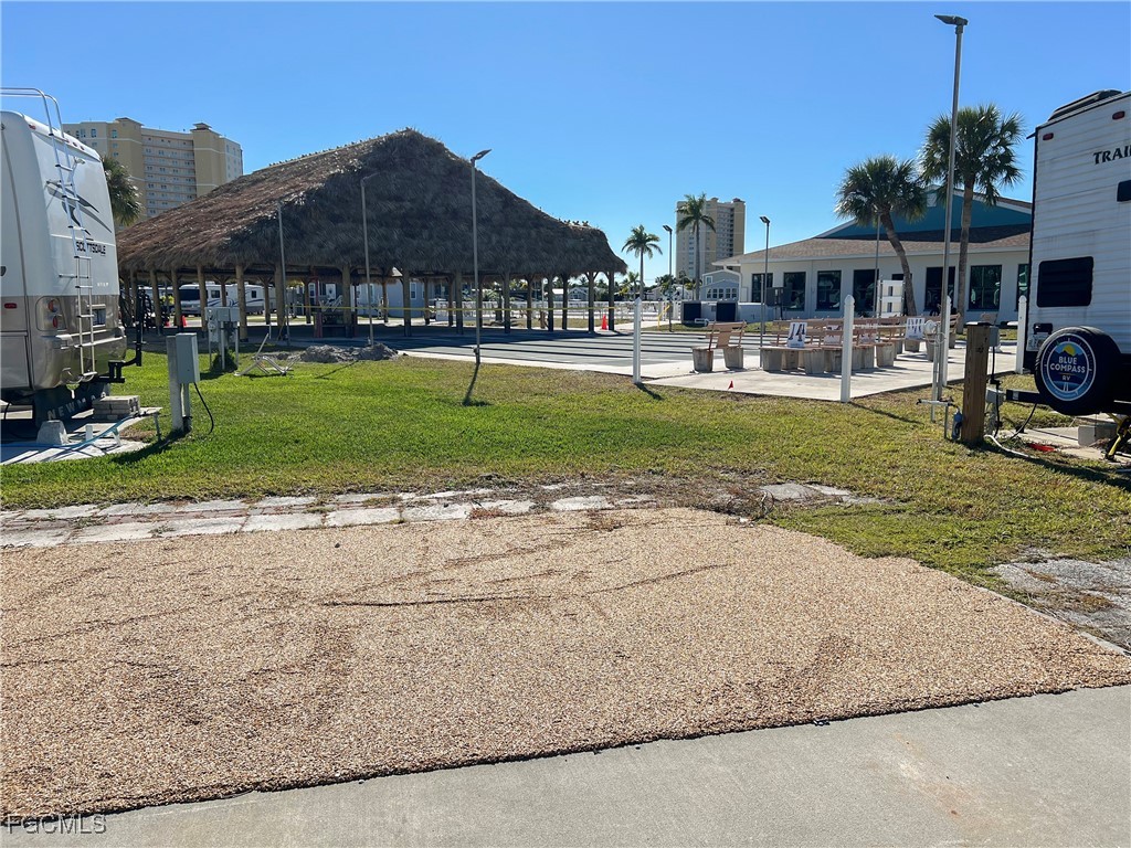 19681 Summerlin Road, Unit 273 Fort Myers, FL 33908 - Photo 7 of 16 a patio with a table and chairs under an umbrella