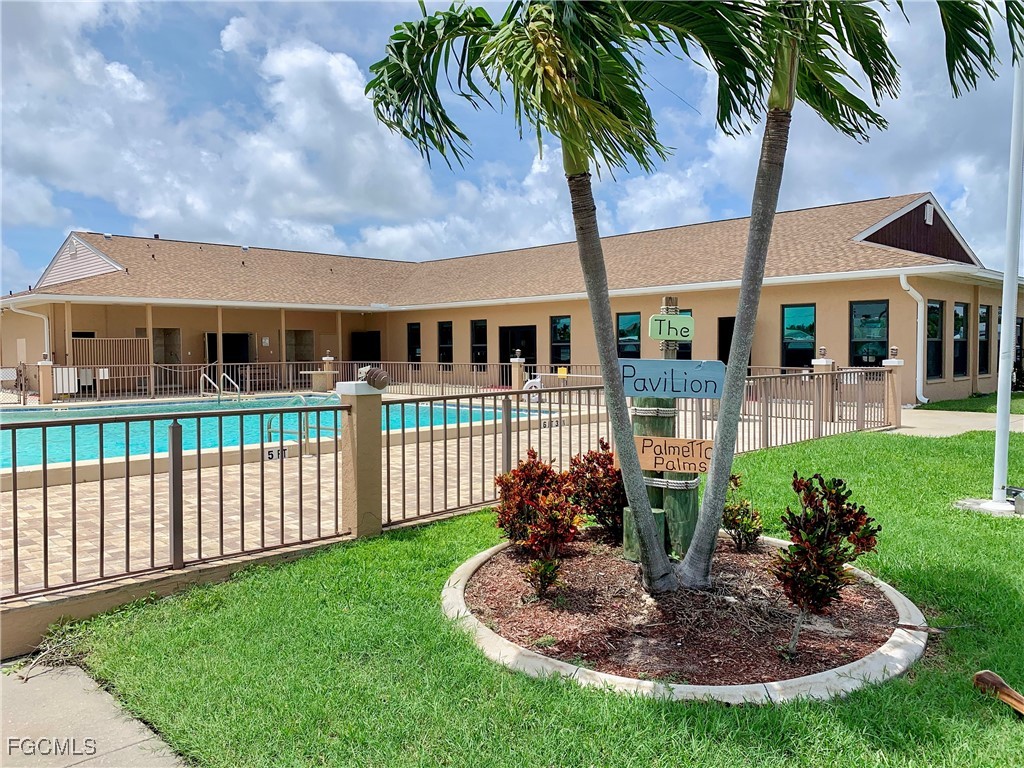 19681 Summerlin Road, Unit 273 Fort Myers, FL 33908 - Photo 9 of 16 a front view of a house with a garden and yard