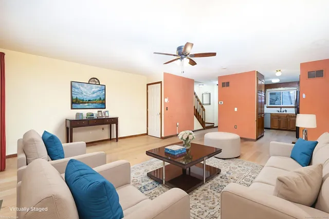 an empty room with closet and a ceiling fan