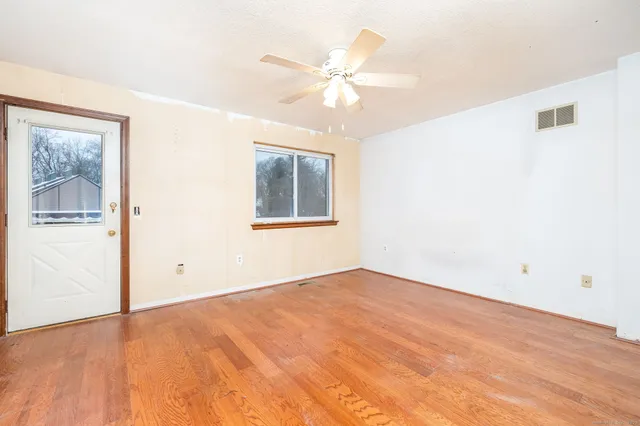 a spacious bedroom with a bed and a chandelier