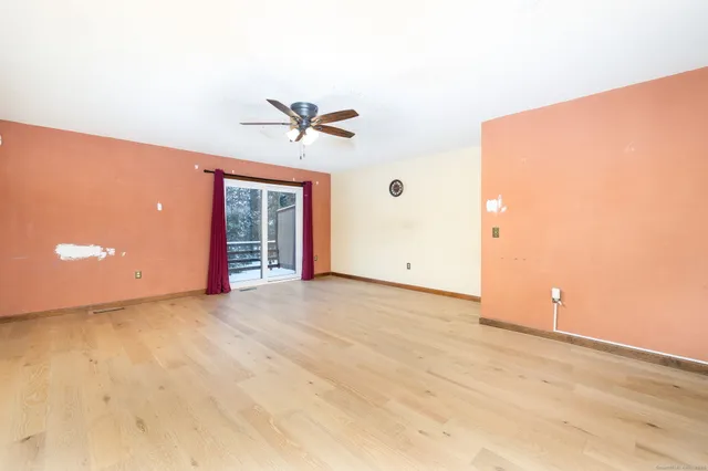 a view of a livingroom with furniture and a flat screen tv