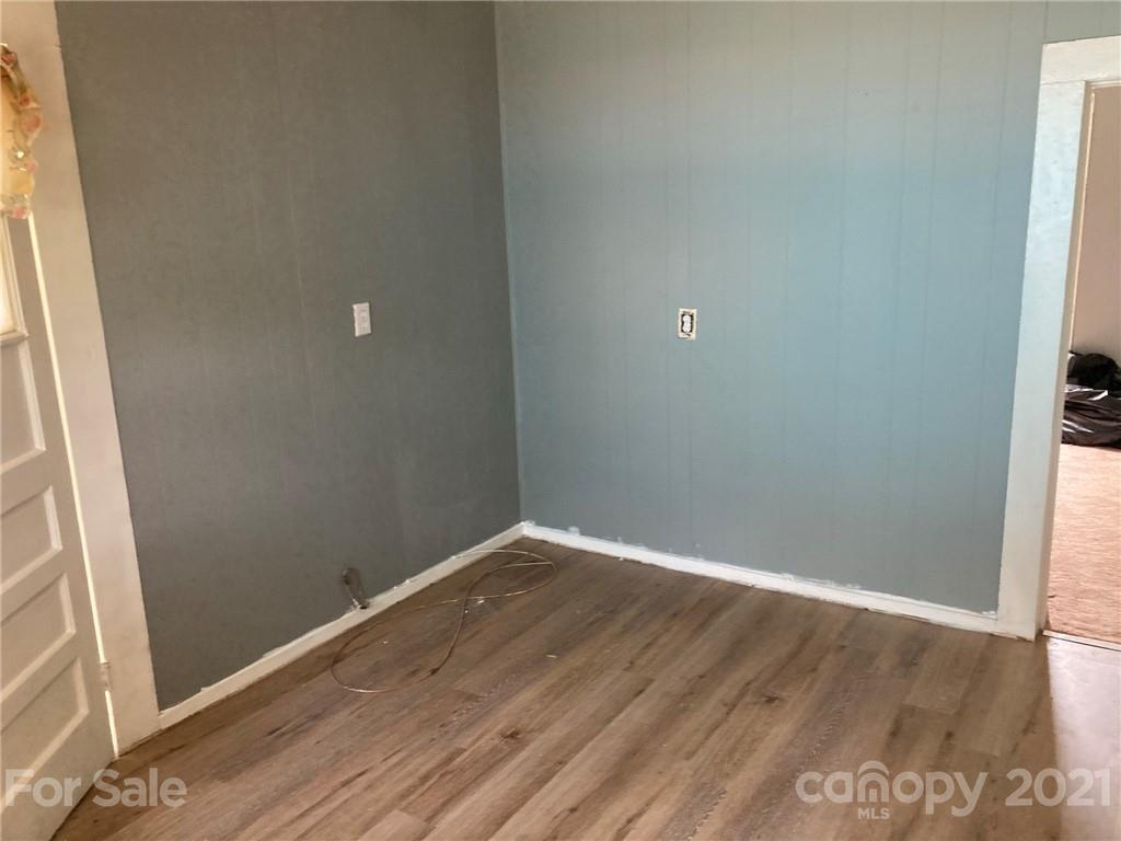 1005 Rickert Street Statesville, NC 28677 - Photo 5 of 10 a view of an empty room with wooden floor and a window