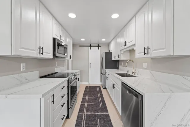 a kitchen with a sink stove and cabinets