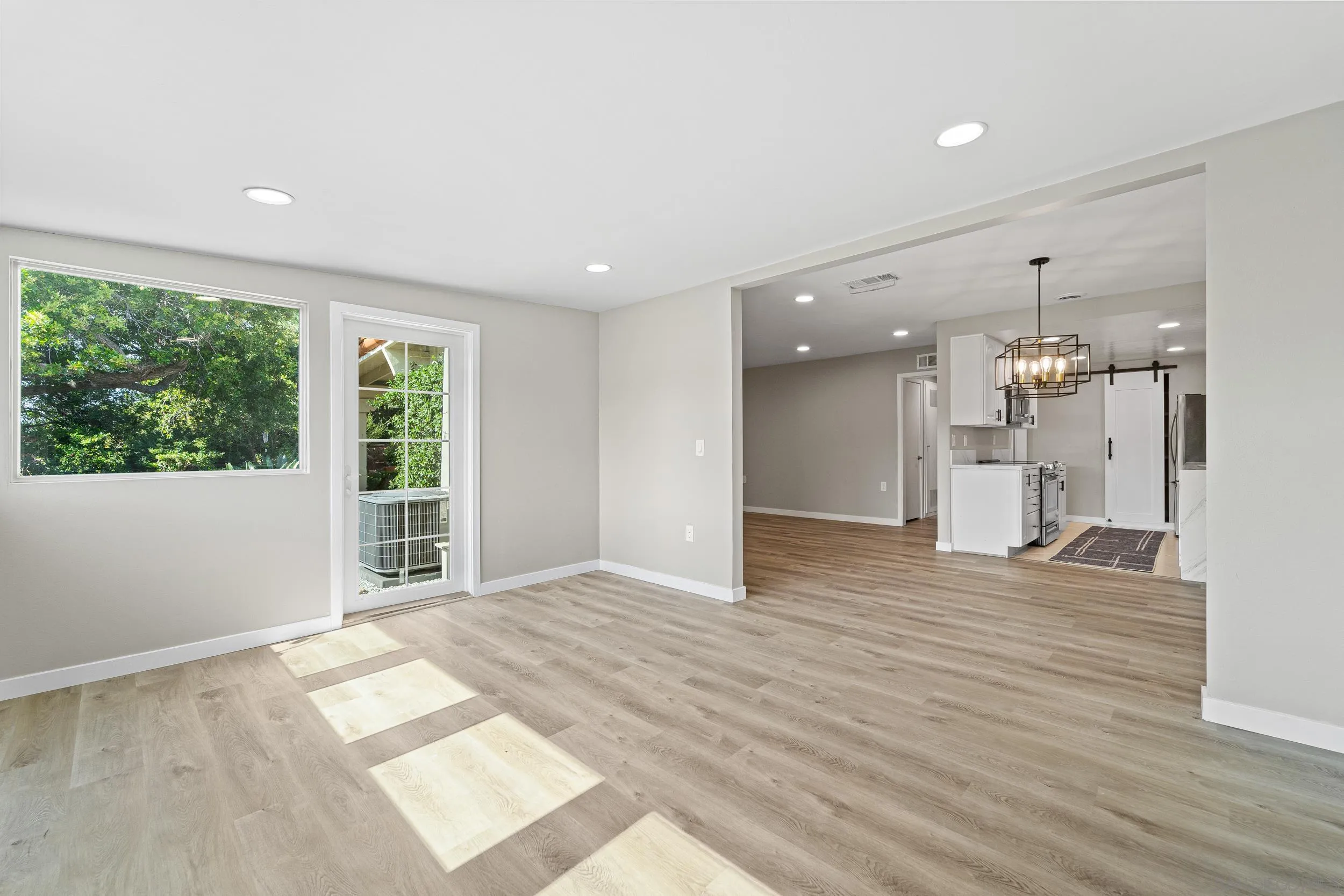 12424 Rios Road San Diego, CA 92128 - Photo 14 of 35 a view of an empty room with wooden floor and a window