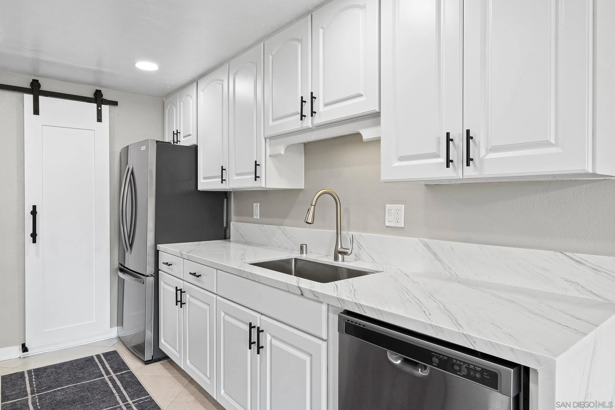 12424 Rios Road San Diego, CA 92128 - Photo 18 of 35 a kitchen with stainless steel appliances granite countertop a sink stove and refrigerator