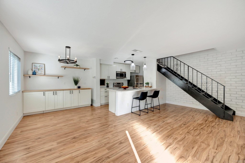 a view of kitchen with furniture and wooden floor