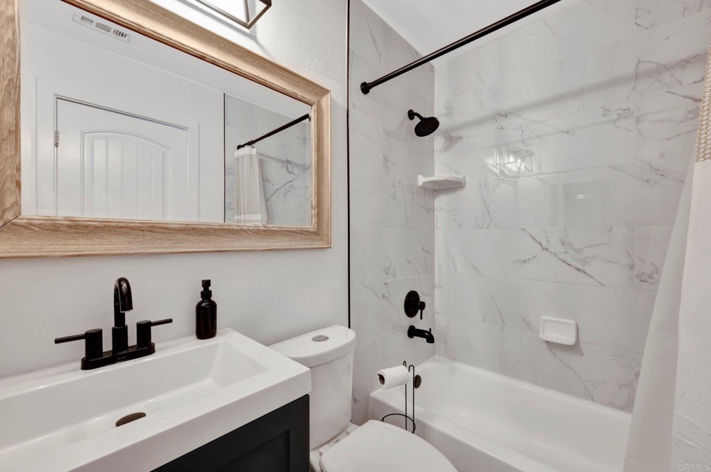 9932 Mission Vega Road, Unit 2 Santee, CA 92071 - Photo 21 of 28 a bathroom with a sink a toilet and shower