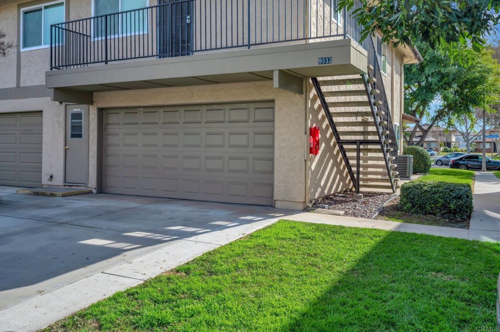 9932 Mission Vega Road, Unit 2 Santee, CA 92071 - Photo 23 of 28 a front view of a house with a yard and garage