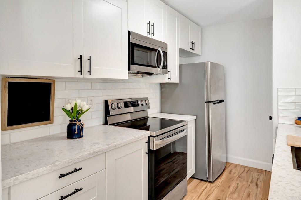 9932 Mission Vega Road, Unit 2 Santee, CA 92071 - Photo 7 of 28 a kitchen with a refrigerator and microwave