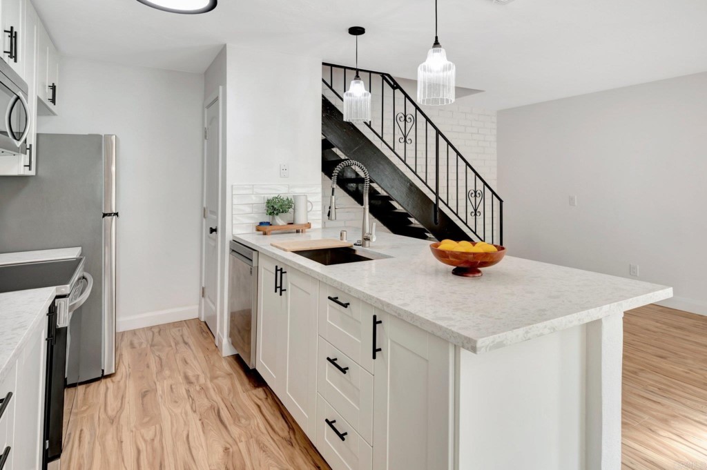 9932 Mission Vega Road, Unit 2 Santee, CA 92071 - Photo 9 of 28 a hallway with sink a washer and dryer