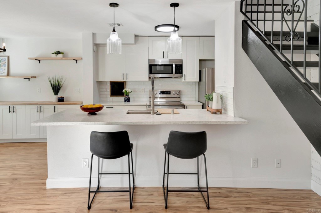 9932 Mission Vega Road, Unit 2 Santee, CA 92071 - Photo 10 of 28 a kitchen with stainless steel appliances granite countertop a sink and a refrigerator