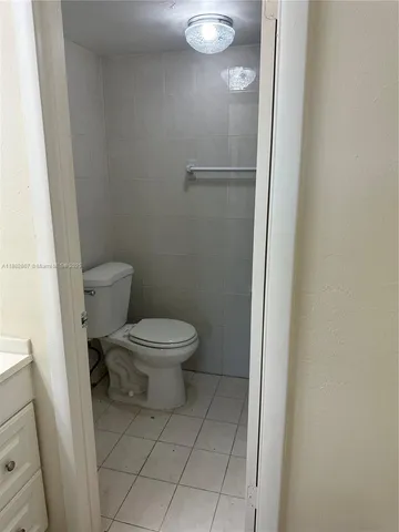 a white toilet sitting next to a white sink