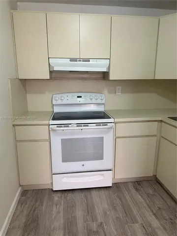 a stove top oven sitting inside of a kitchen