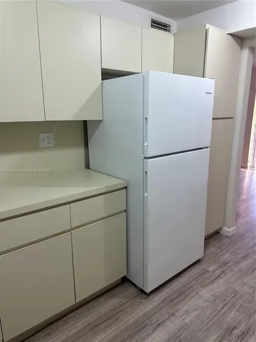 a white refrigerator freezer sitting in a kitchen