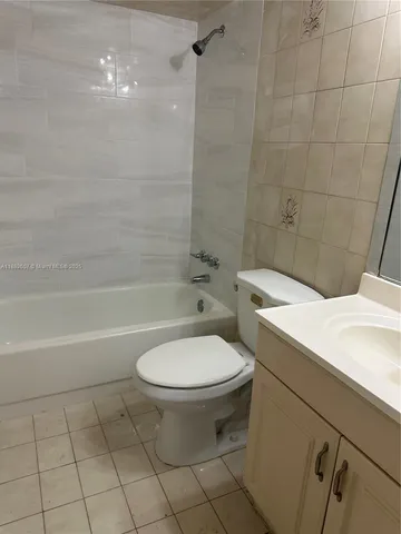 a bathroom with a toilet a sink and bathtub