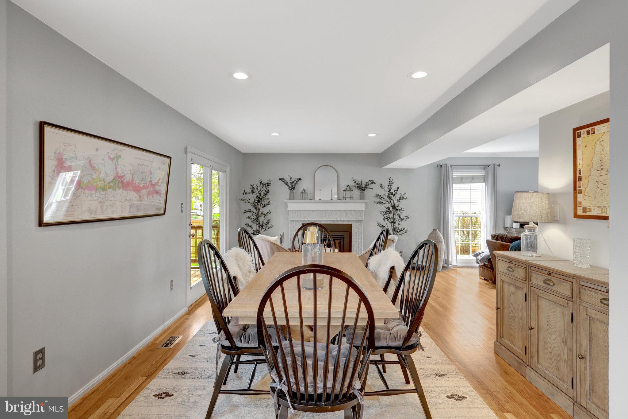 44116 Bristow Circle Ashburn, VA 20147 - Photo 18 of 79 a view of a dining room with furniture a chandelier and wooden floor