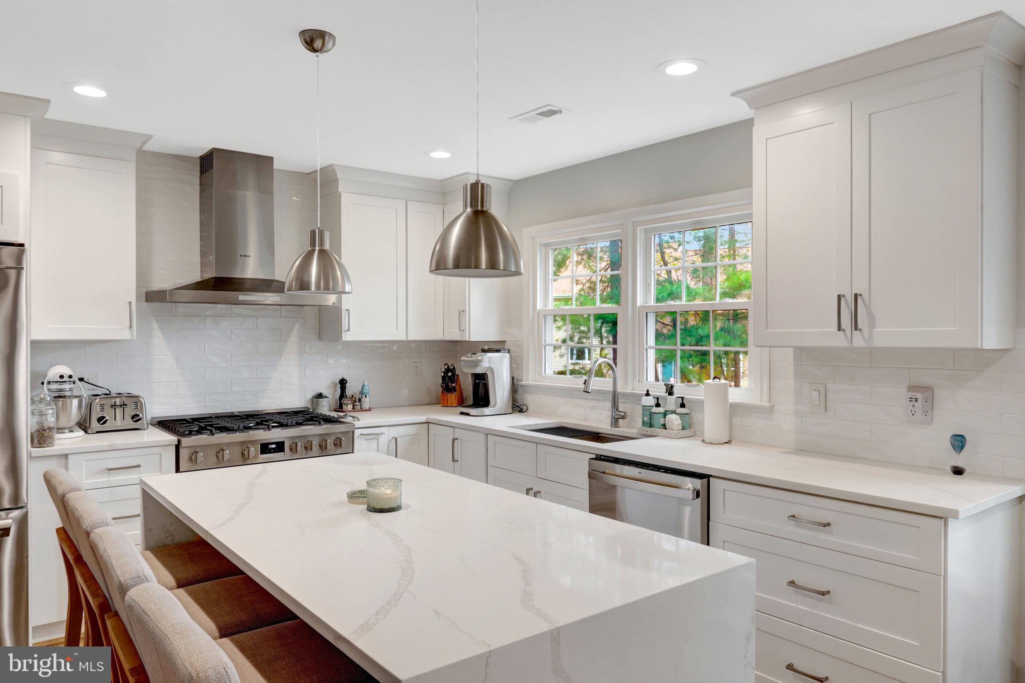 44116 Bristow Circle Ashburn, VA 20147 - Photo 23 of 79 a kitchen with a sink a stove and cabinets