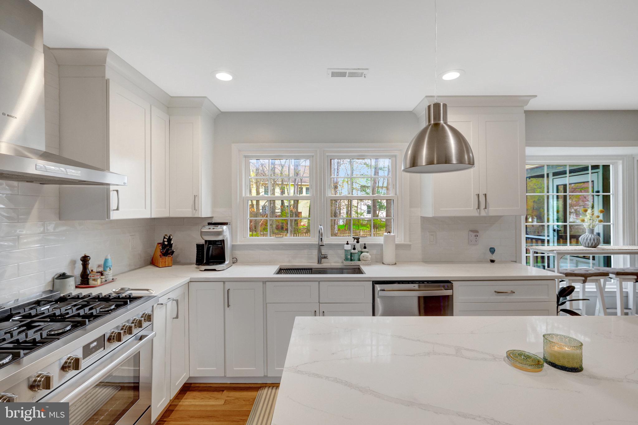 44116 Bristow Circle Ashburn, VA 20147 - Photo 27 of 79 a kitchen with stainless steel appliances a sink stove and cabinets