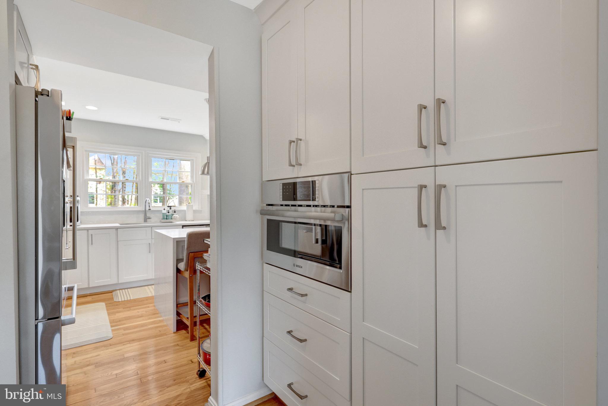 44116 Bristow Circle Ashburn, VA 20147 - Photo 29 of 79 a kitchen with white cabinets and stainless steel appliances