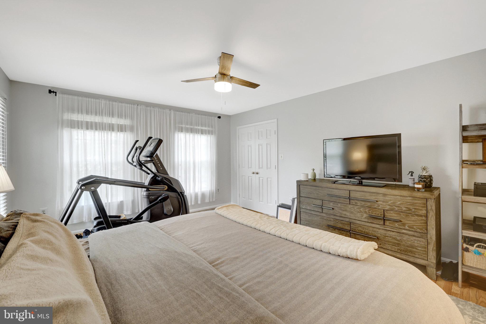 44116 Bristow Circle Ashburn, VA 20147 - Photo 37 of 79 a bedroom with a bed and a flat screen tv