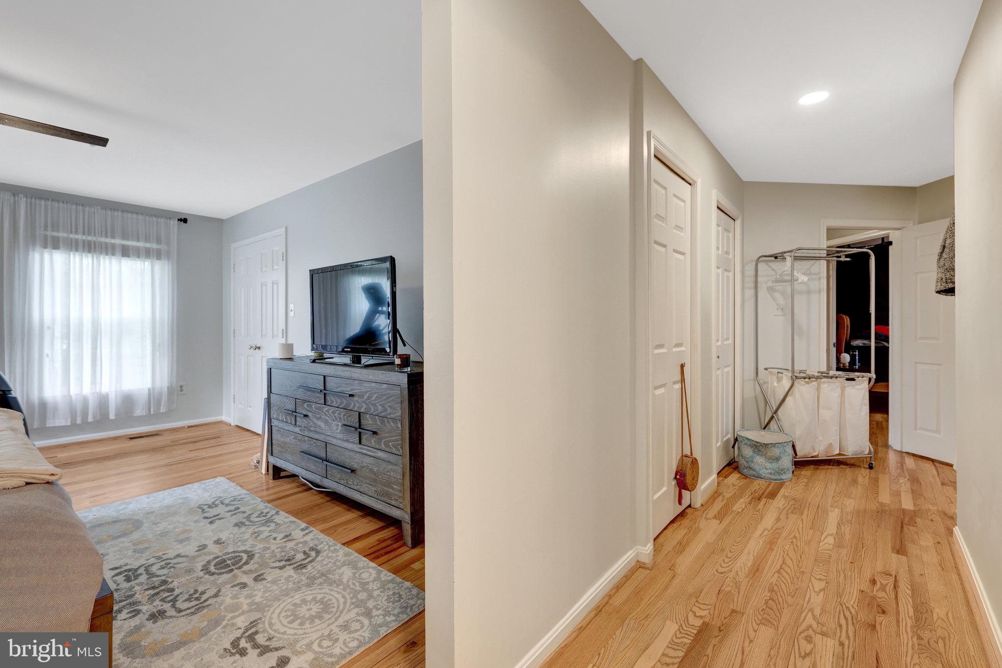 44116 Bristow Circle Ashburn, VA 20147 - Photo 39 of 79 a view of a bedroom with wooden floor and a bed