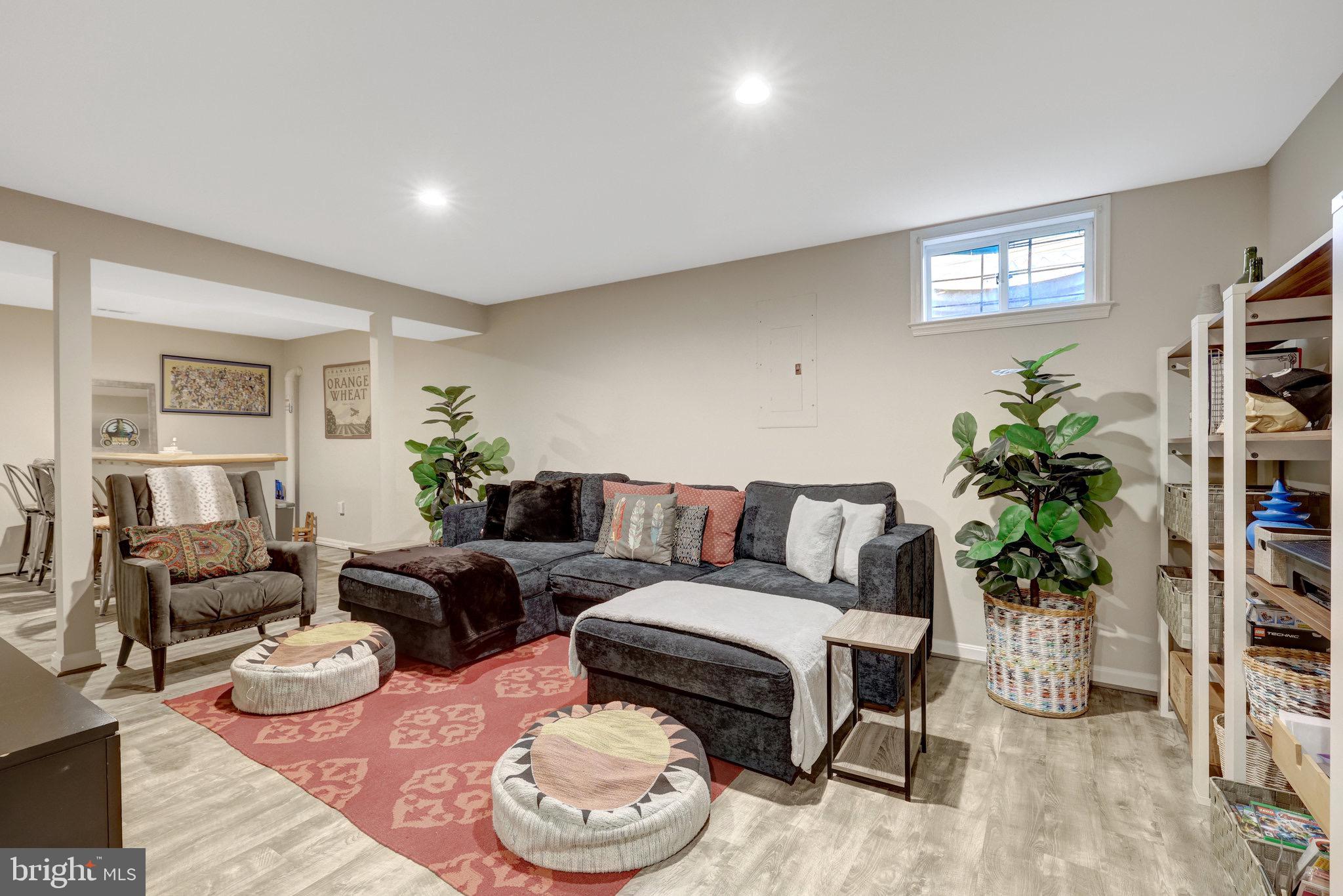 44116 Bristow Circle Ashburn, VA 20147 - Photo 52 of 79 a living room with furniture and a bookshelf