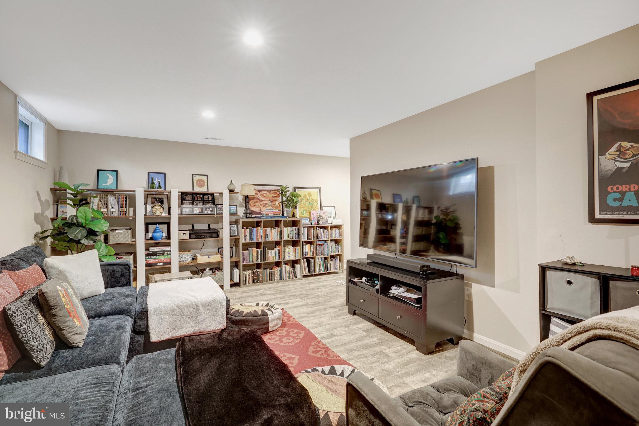 44116 Bristow Circle Ashburn, VA 20147 - Photo 53 of 79 a living room with furniture and a flat screen tv