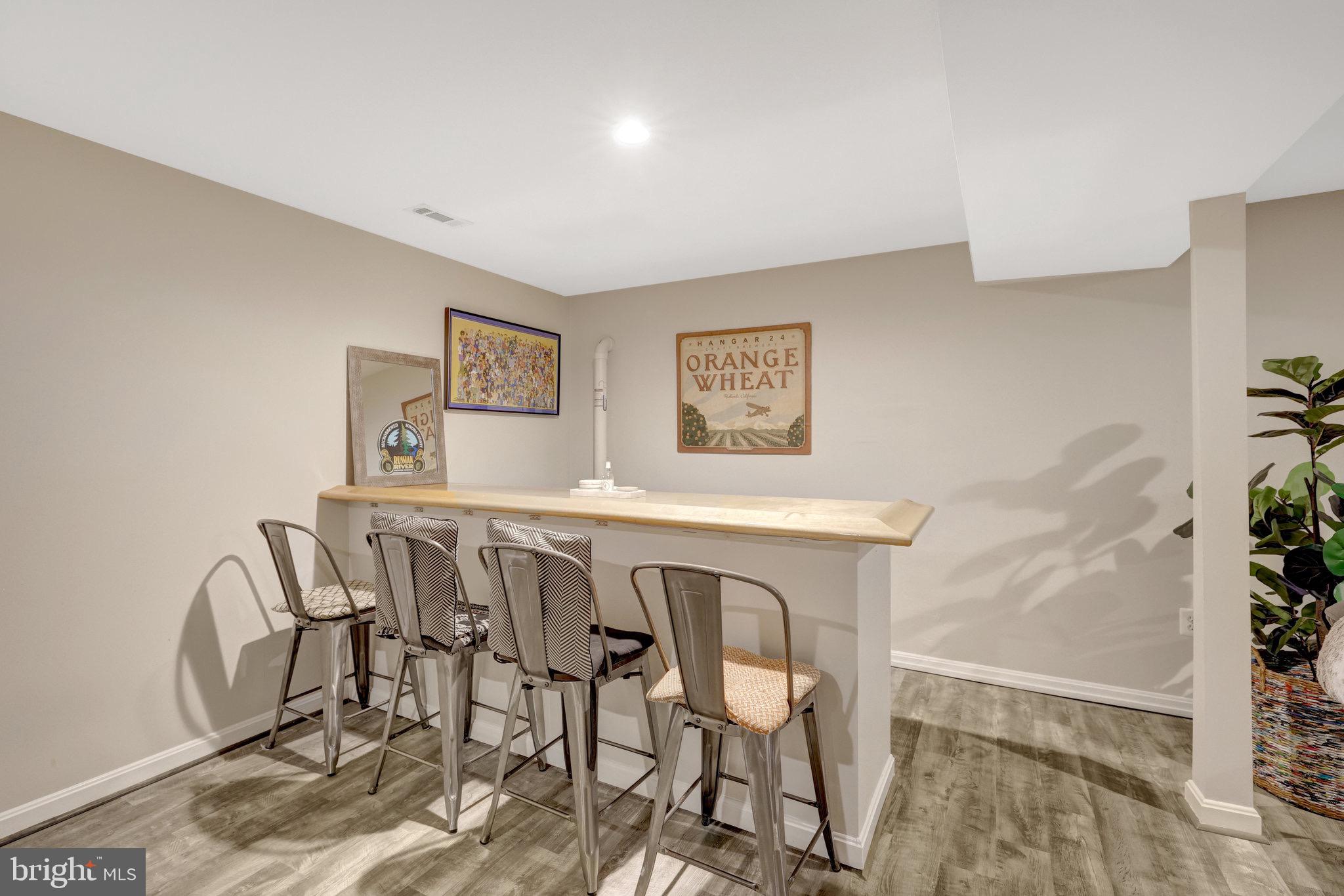 44116 Bristow Circle Ashburn, VA 20147 - Photo 56 of 79 a view of a dining room with furniture and wooden floor