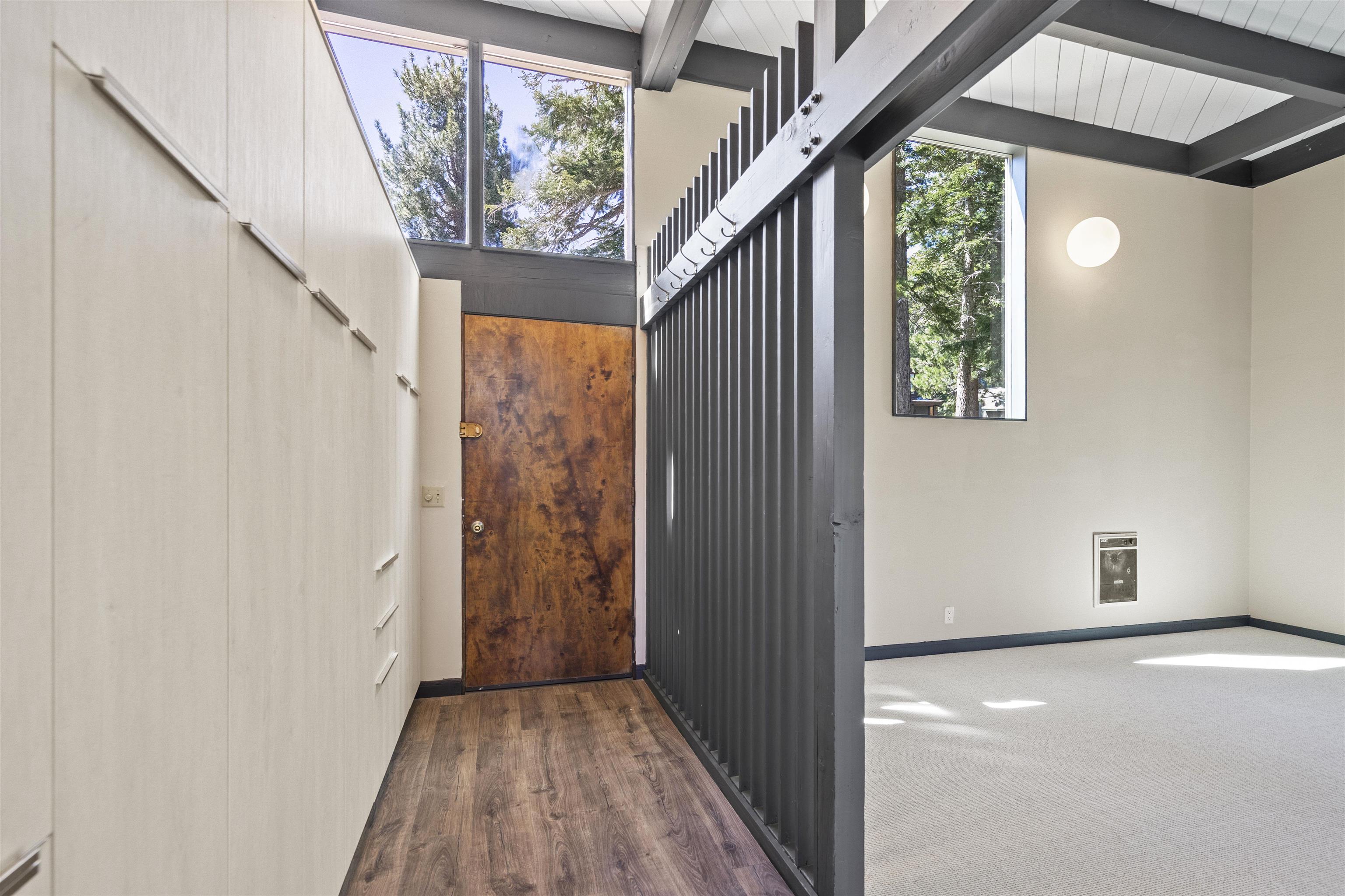2570 Old Mammoth Road Mammoth Lakes, CA 93546 - Photo 20 of 39 Entryway featuring wood-finish flooring, a wood-panel door, and integrated wall storage