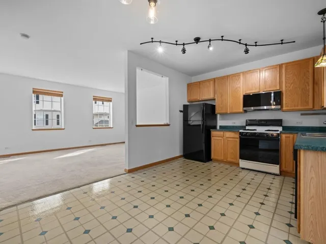a kitchen with stainless steel appliances a refrigerator and a stove top oven
