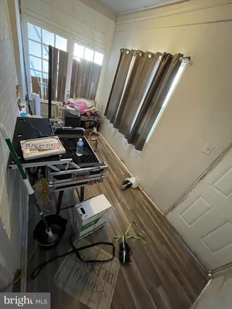 a view of a room with chairs and wooden floor