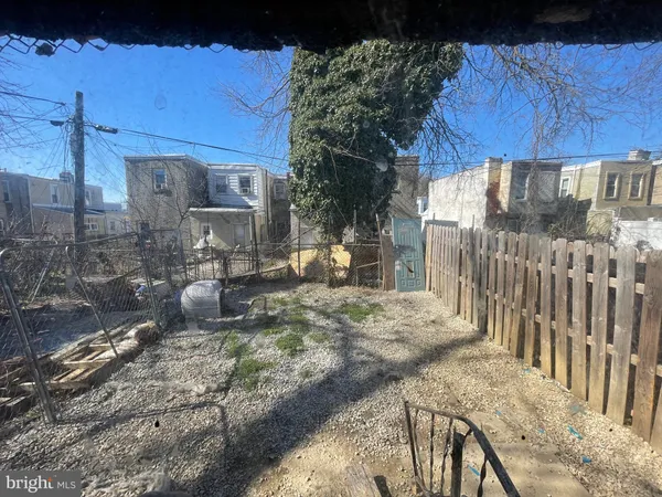 a view of a backyard with wooden fence