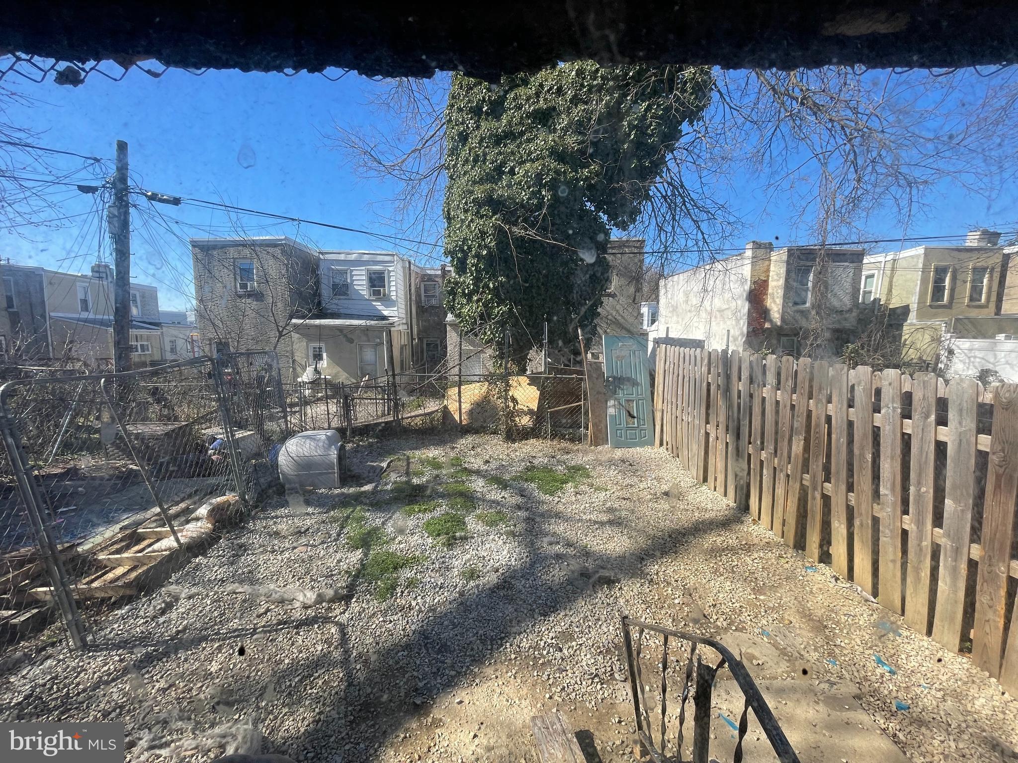 902 Maple Terrace Darby, PA 19023 - Photo 3 of 9 a view of a backyard with wooden fence