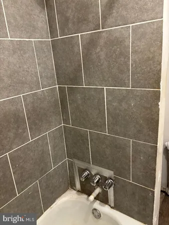a bathroom with a toilet a sink and a mirror