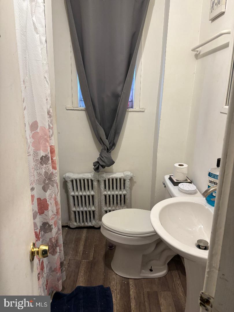 902 Maple Terrace Darby, PA 19023 - Photo 8 of 9 a bathroom with a toilet a sink and a mirror