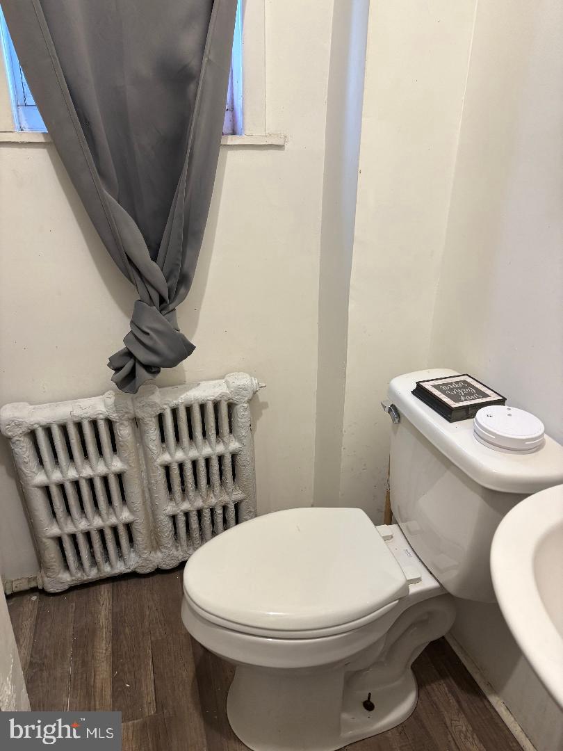 902 Maple Terrace Darby, PA 19023 - Photo 9 of 9 a white toilet sitting next to a bathroom sink