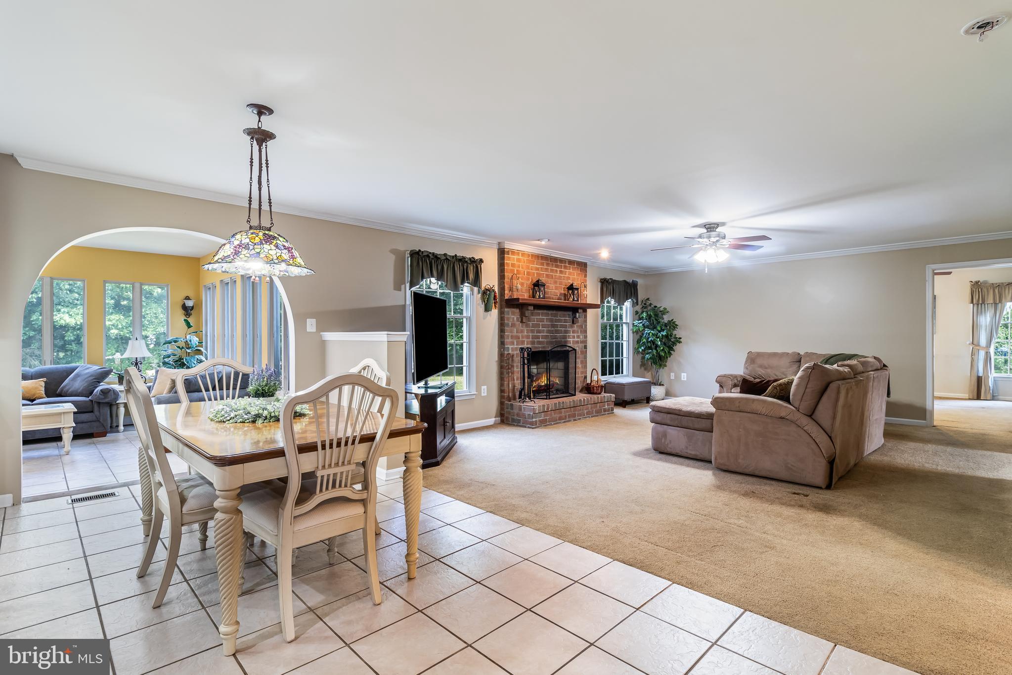 203 Morgans Ridge Court La Plata, MD 20646 - Photo 20 of 59 a living room with furniture a chandelier and a fireplace