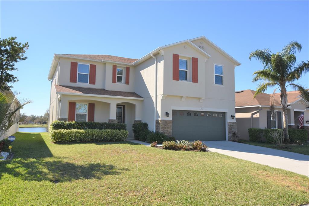 4267 Moon Shadow Loop Mulberry, FL 33860 - Photo 1 of 39 a front view of a house with a yard and garage