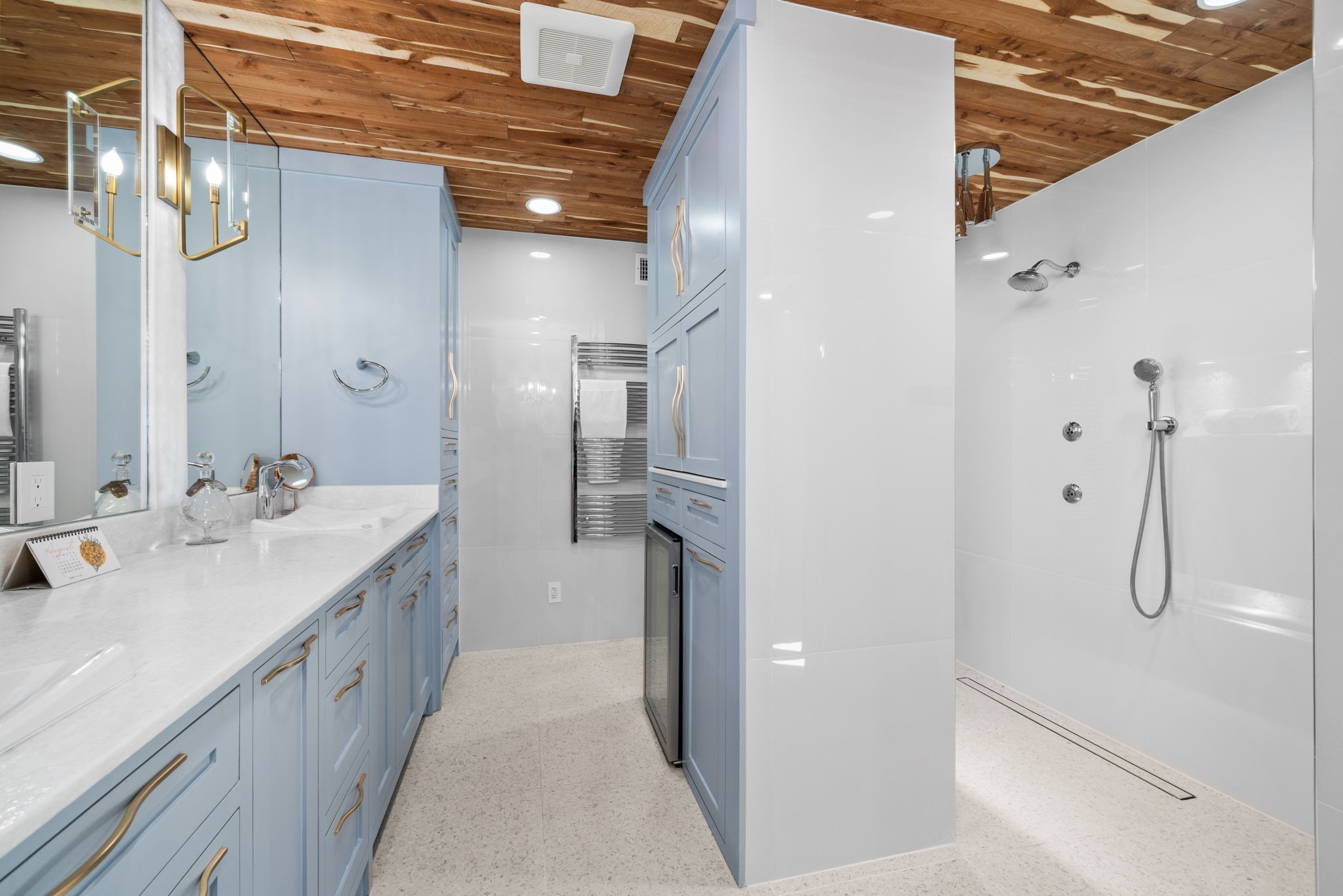 a bathroom with a double vanity sink mirror and shower