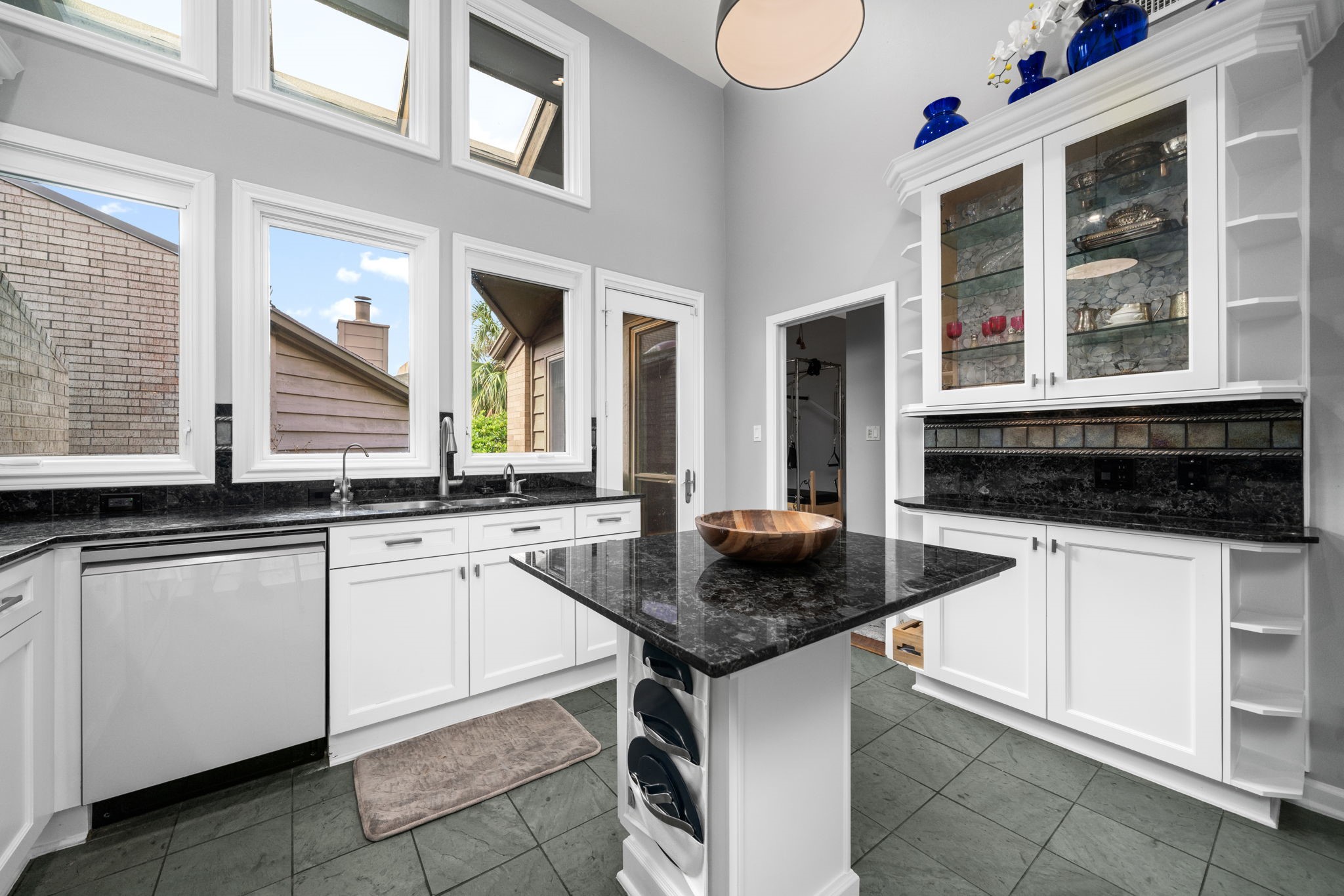 1011 Barkdull Street Houston, TX 77006 - Photo 26 of 40 This kitchen not only has plenty of counter space and cabinets. It has great views and access to the patio that overlooks the common area and pools. Guests bedroom is tucked in back through this doorway.