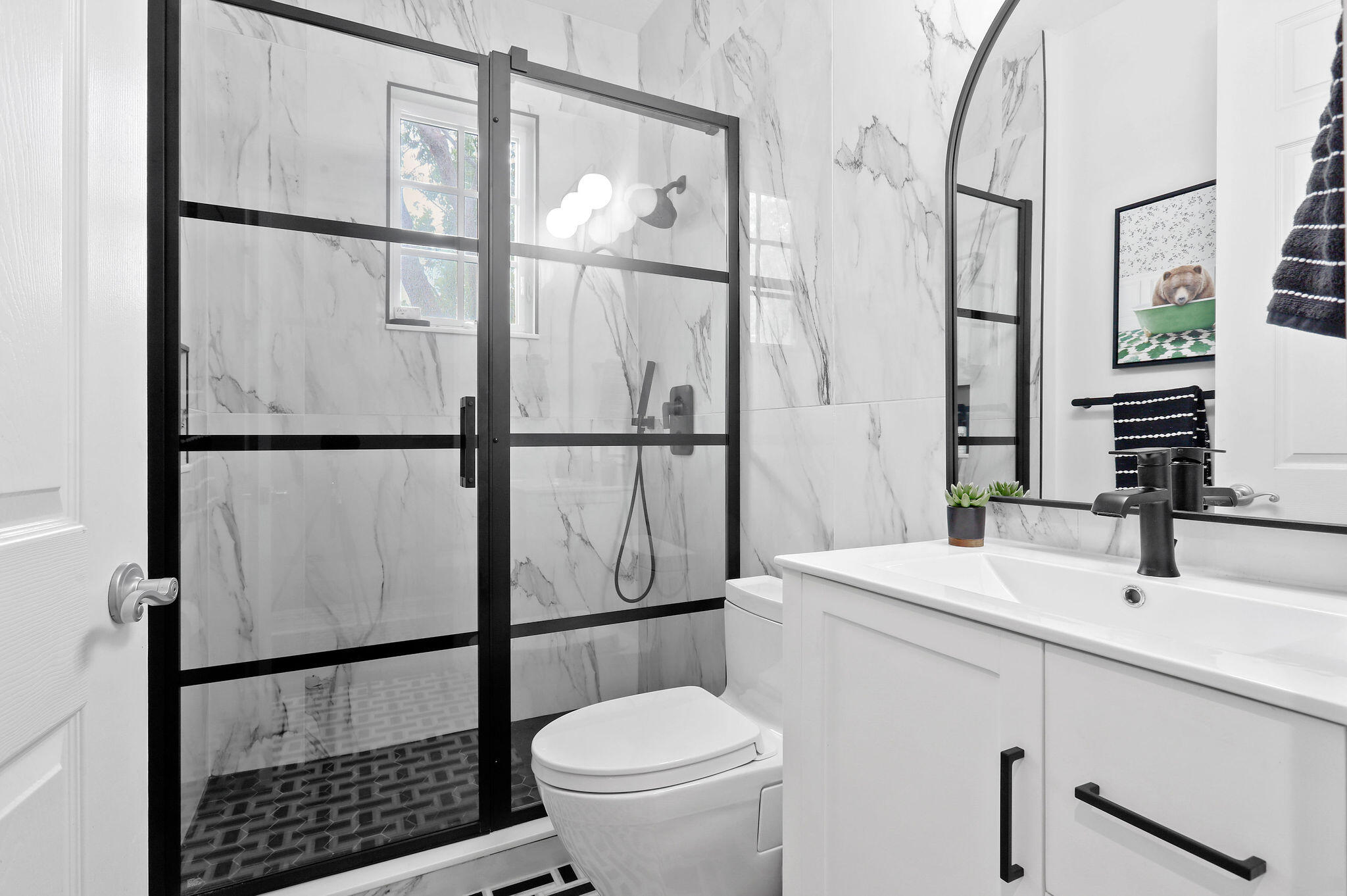 147 Killarney Court Jupiter, FL 33458 - Photo 19 of 68 a bathroom with a sink a mirror a toilet and shower