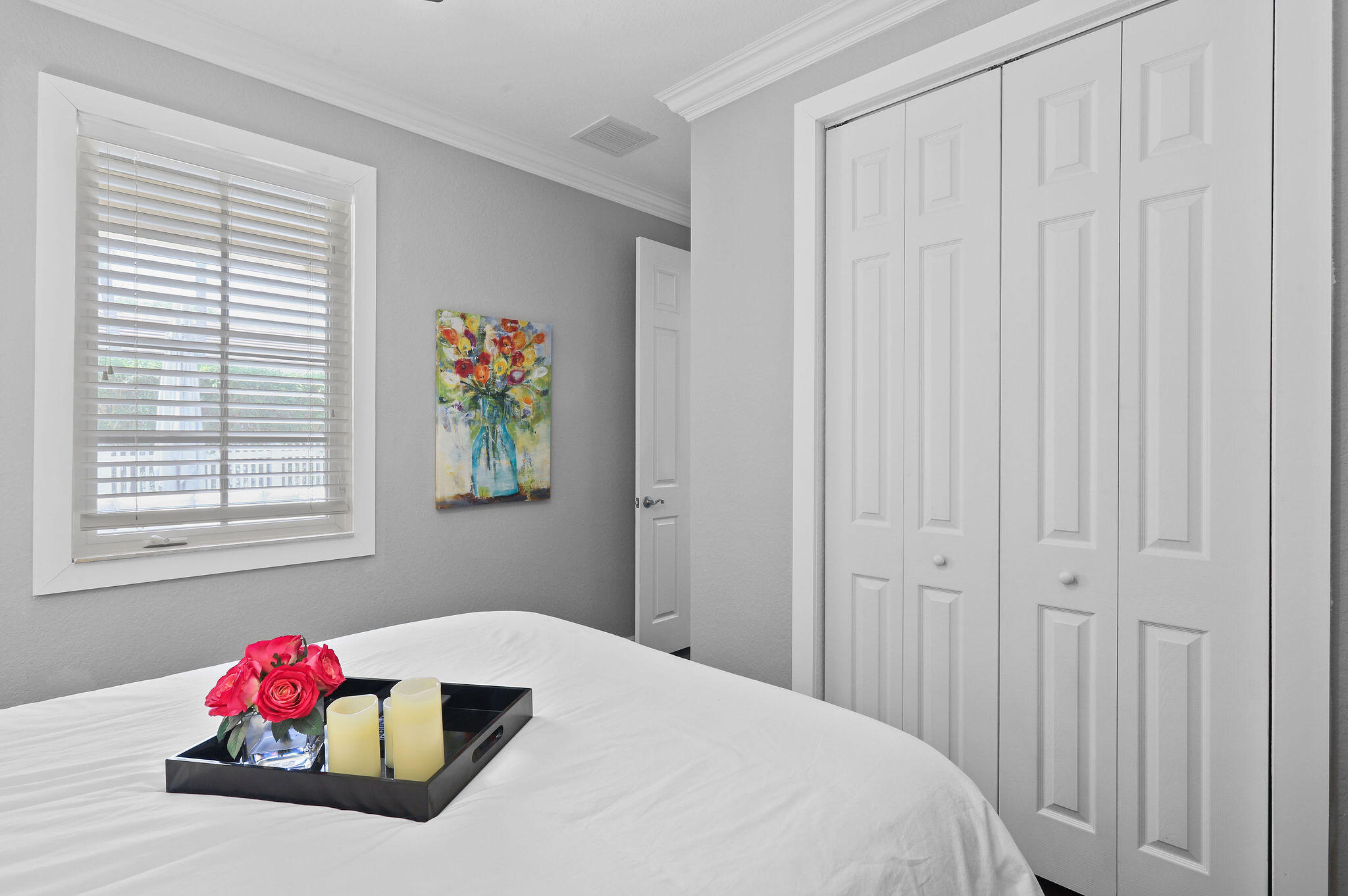 147 Killarney Court Jupiter, FL 33458 - Photo 22 of 68 a bedroom with a bed and a window