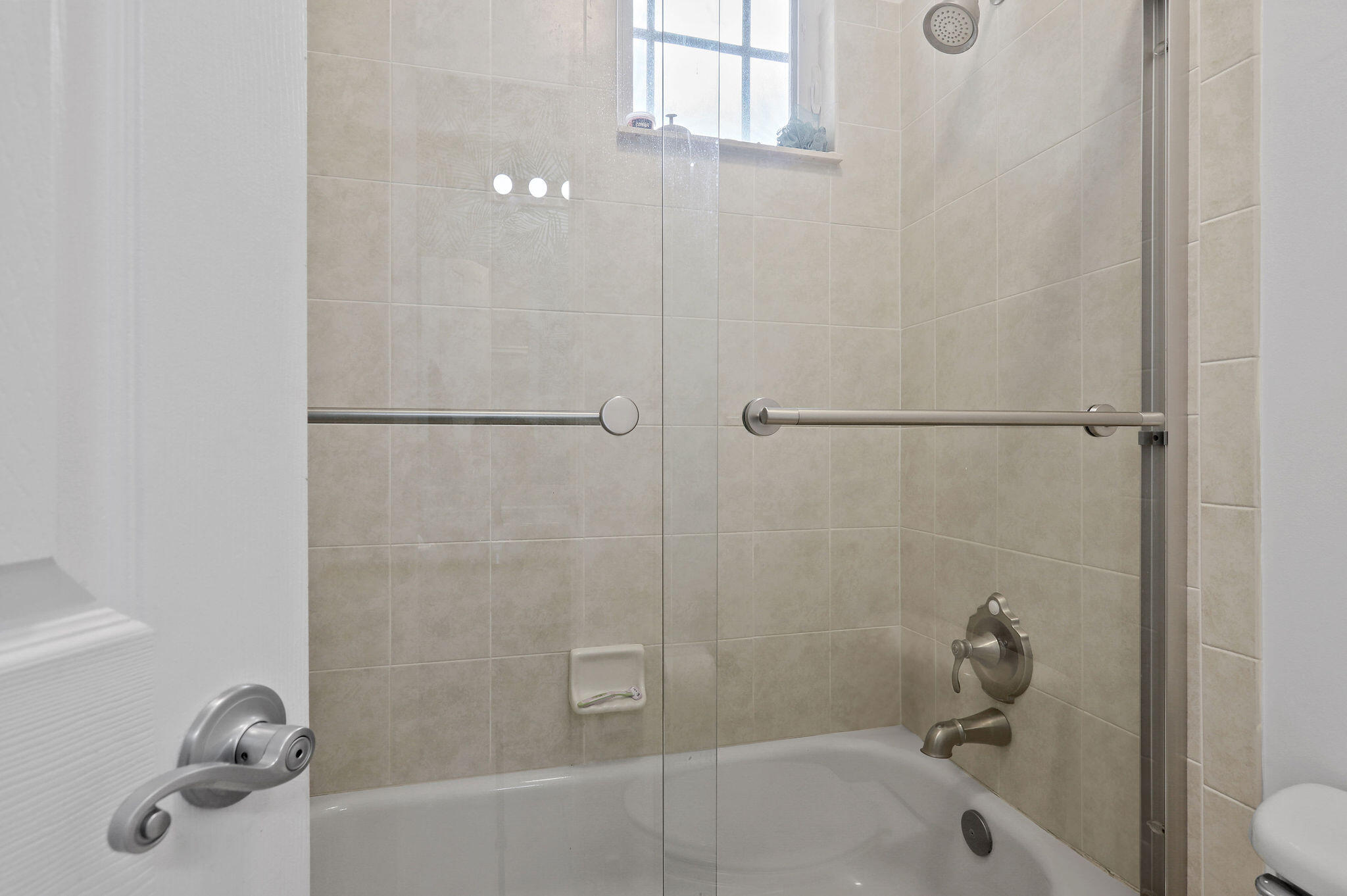 147 Killarney Court Jupiter, FL 33458 - Photo 29 of 68 a bathroom with a tub and a shower