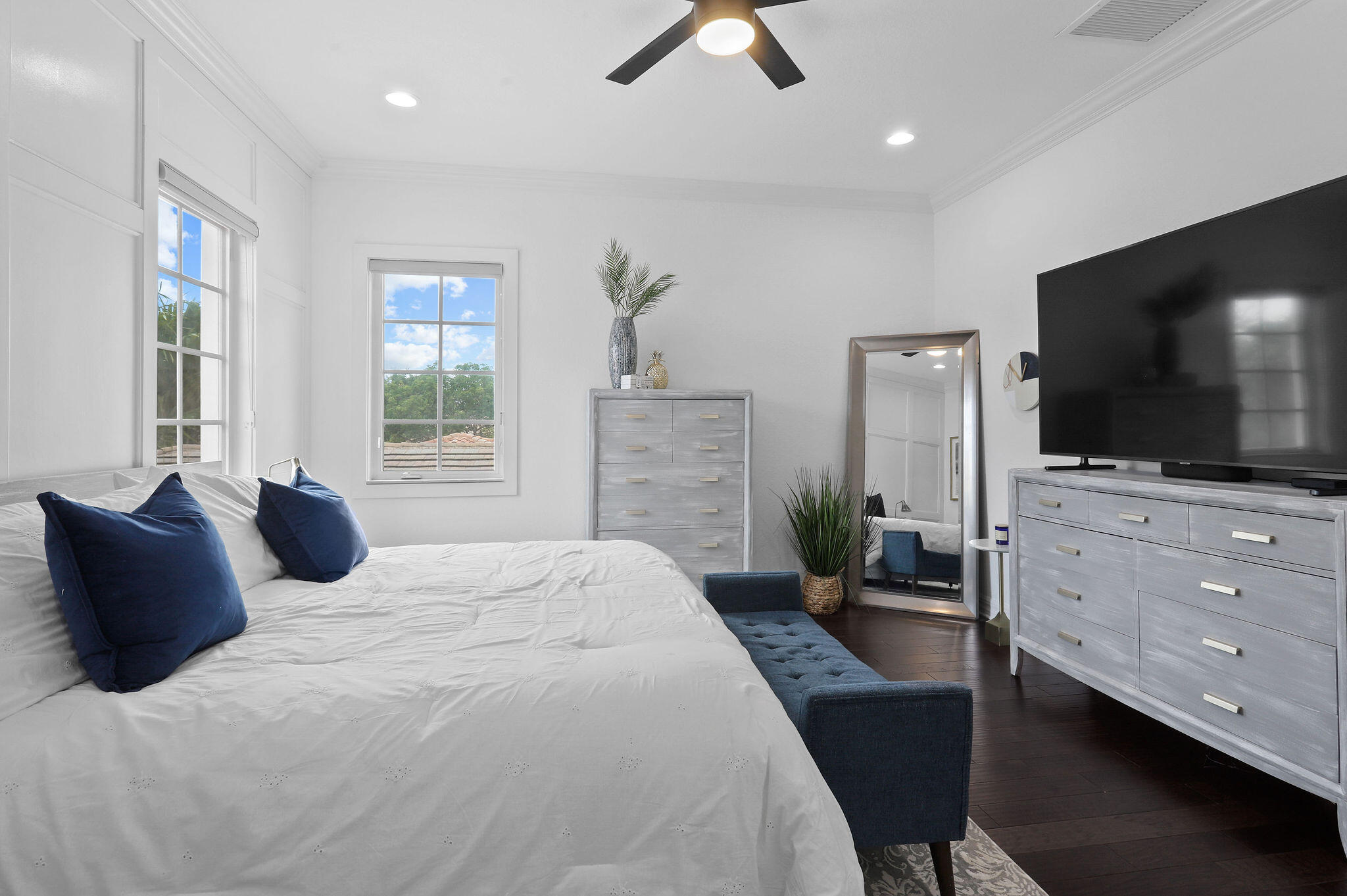 147 Killarney Court Jupiter, FL 33458 - Photo 31 of 68 a bedroom with a bed flat screen tv and a couch