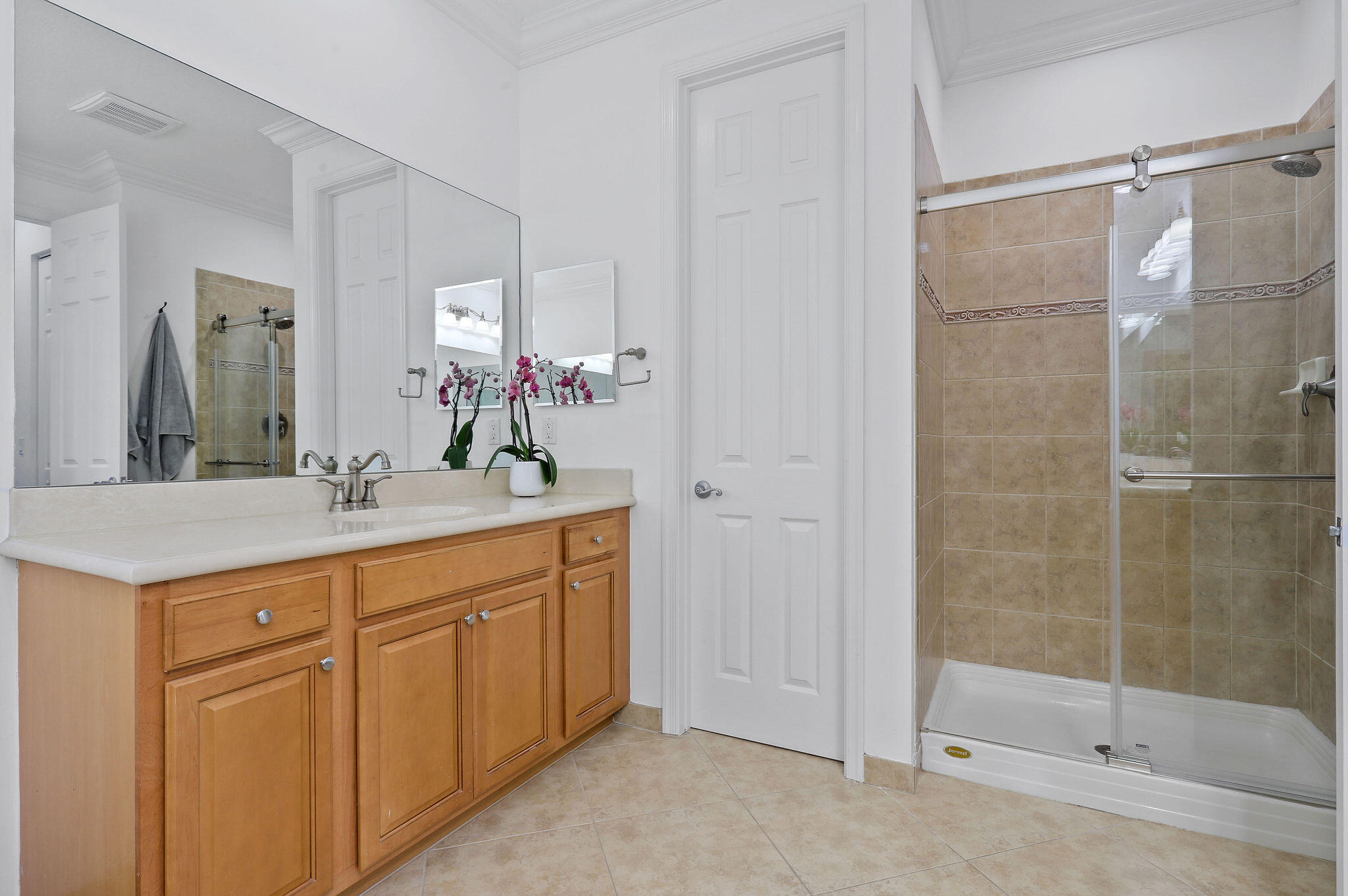 147 Killarney Court Jupiter, FL 33458 - Photo 36 of 68 a bathroom with a shower sink and mirror
