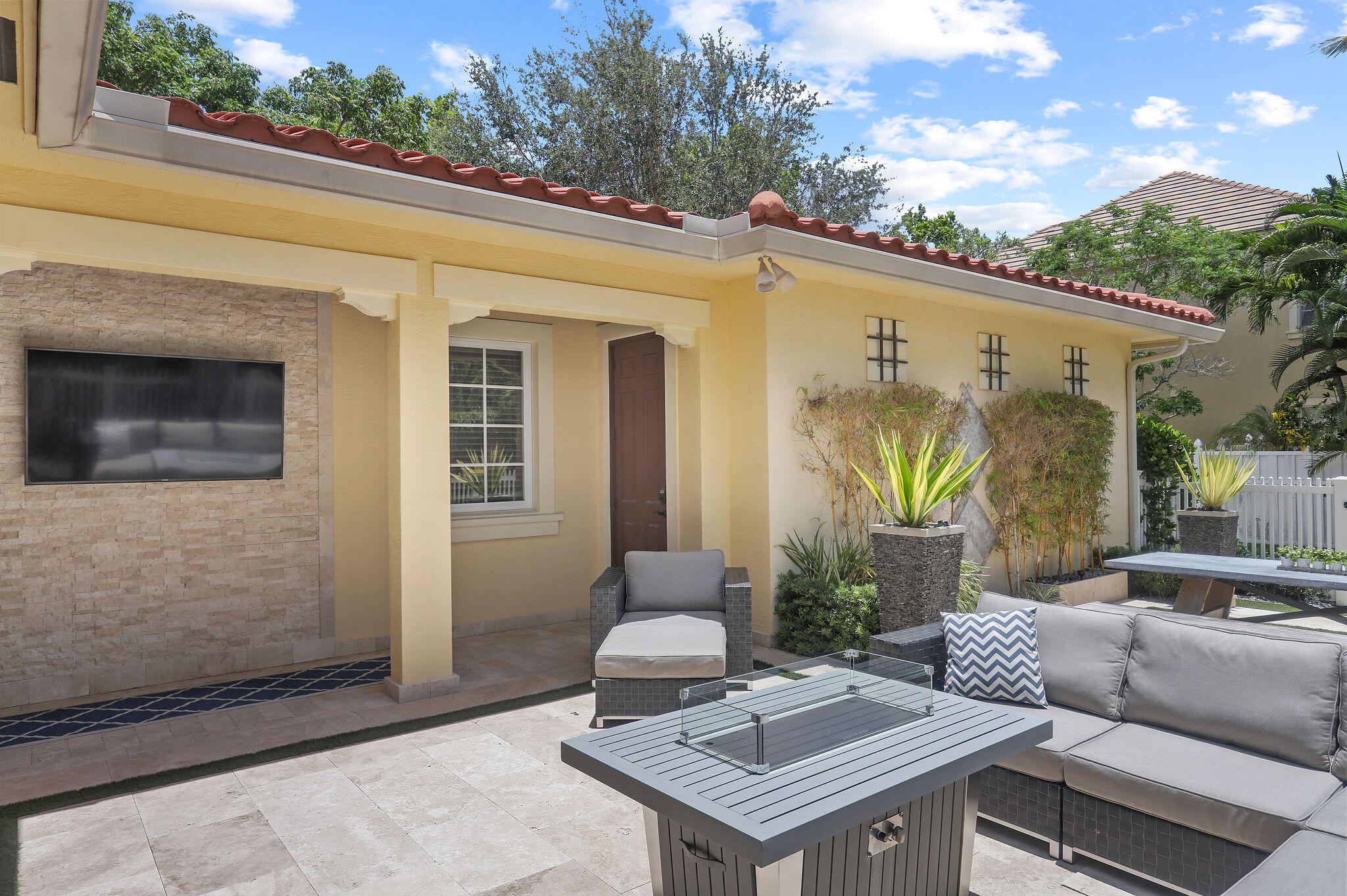 147 Killarney Court Jupiter, FL 33458 - Photo 42 of 68 a view of a patio with couches table and chairs and potted plants