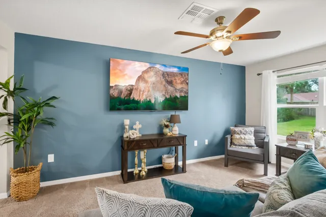 a bathroom with a granite countertop double vanity sinks a mirror and a toilet