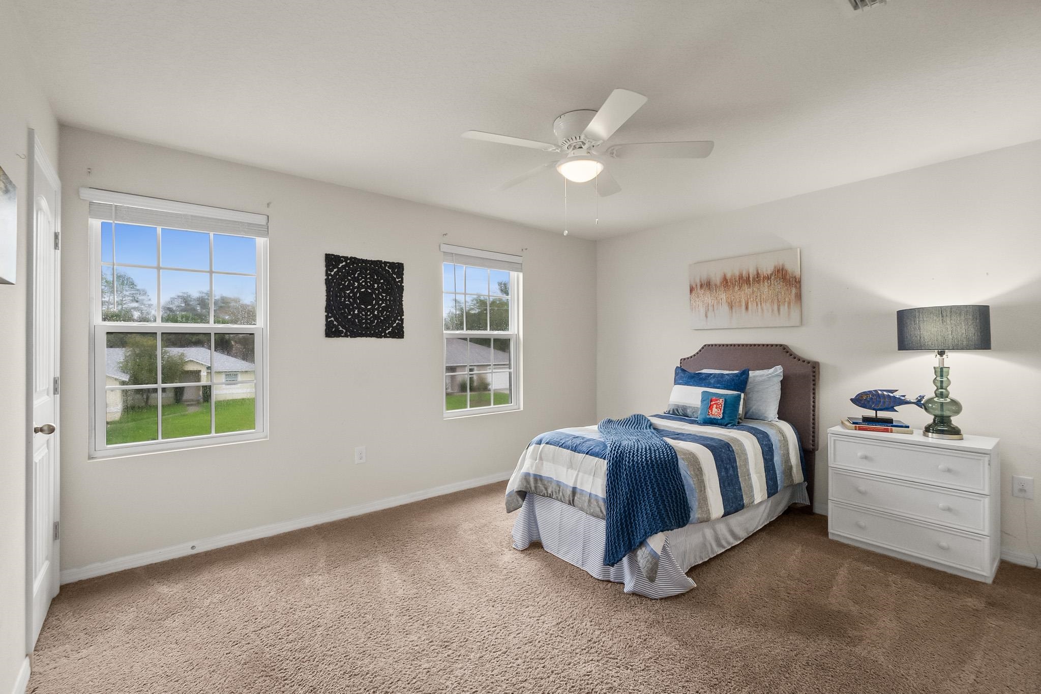 10 Pickcane Lane Palm Coast, FL 32164 - Photo 33 of 43 a spacious bedroom with a bed and a window