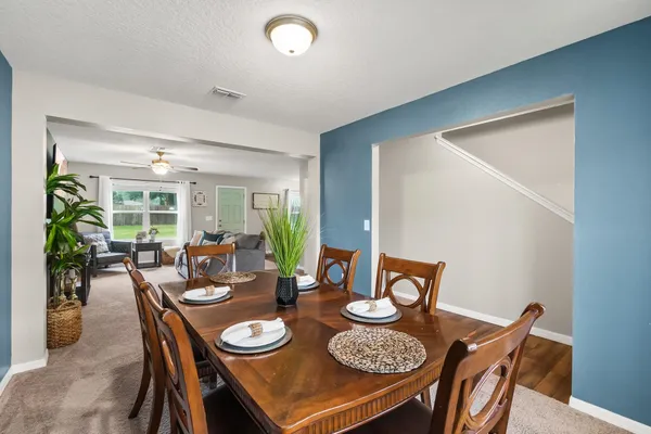 a kitchen with stainless steel appliances granite countertop wooden cabinets a stove top oven a sink and dishwasher with wooden floor
