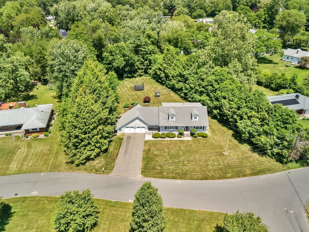 an aerial view of a house with a swimming pool